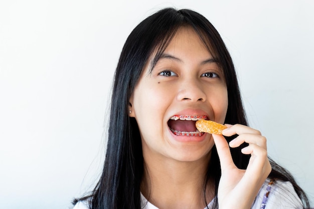 Dental Brace Girl Smiling and Looking to Camera on White Background, She Feel Happy and Have Good Attitude with Dentist.  Motivate Kids not Fear When they have to go to Dental Clinic.