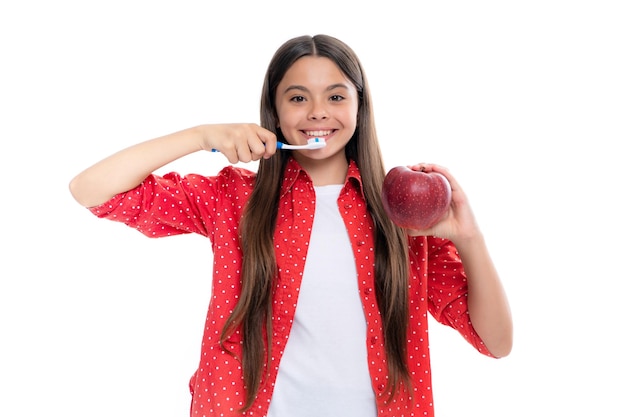 Dental care hygiene and child Teenage girl with toothbrush brushing teeth Apple vitamins for healthy teeth Portrait of happy smiling teenage child girl