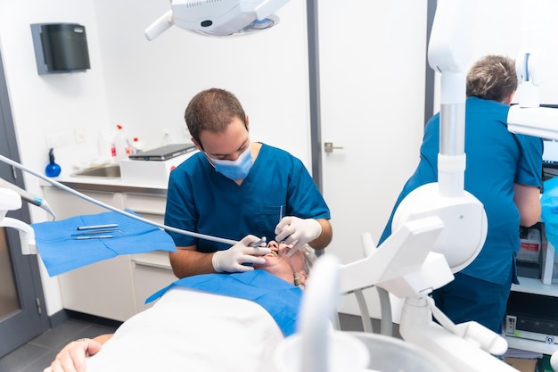 Dental clinic elderly woman at the dentist checking the implants with the dentist doctor