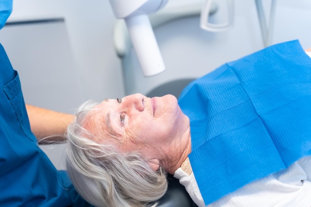 Dental clinic elderly woman lying at the dentist on denture checkup