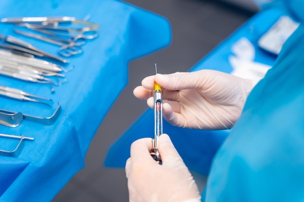 Dental clinic female dentist doctor preparing anesthesia injection before operation