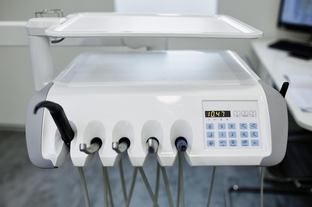 Dental equipment in the office of a dentist doctor with gray walls against the backdrop of bright light from the window