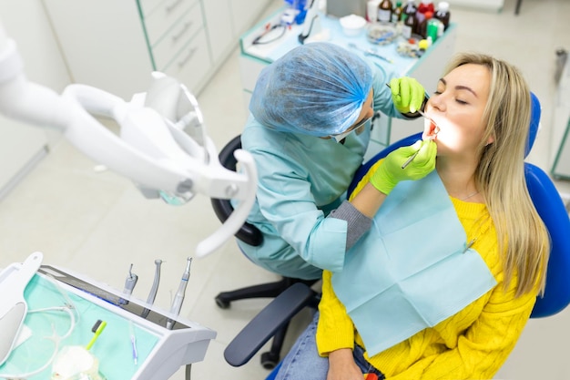 Dental health concept female mouth on treatment in a dental clinic