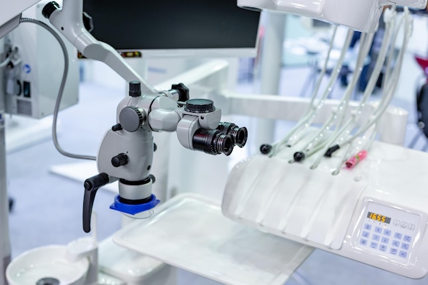 Dental microscope on the background of modern dentistry Medical equipment Dental operating microscope with rotary double binocular