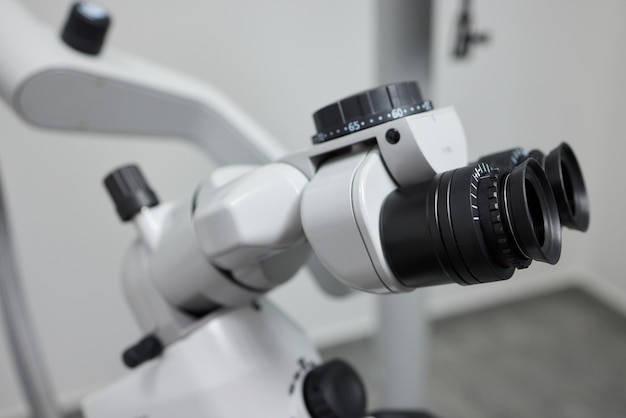 Dental microscope on the background of modern dentistry Medical equipment Dental operating microscope with rotary double binocular