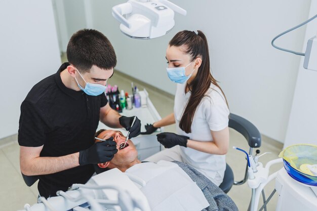 Dental office examining a patient in a dental chair Dental treatment is performed by a doctor and an assistant Dental care