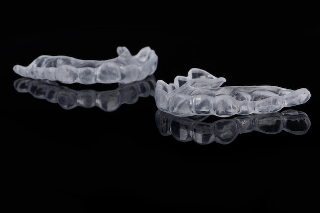 Dental orthodontic silicone caps on a black reflective glossy background