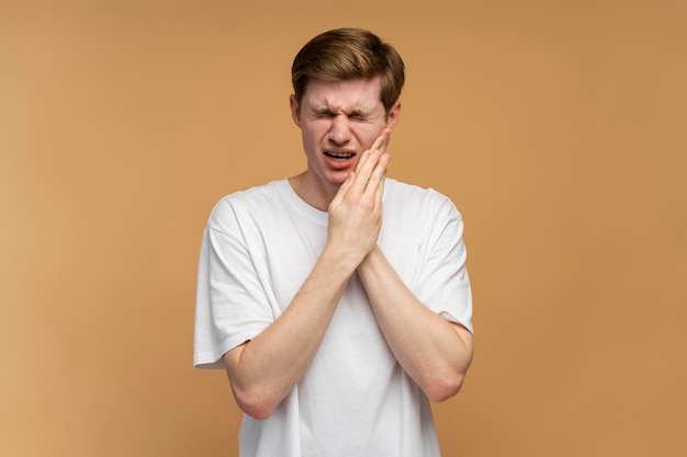 Dental problems Portrait of unhealthy man pressing sore cheek