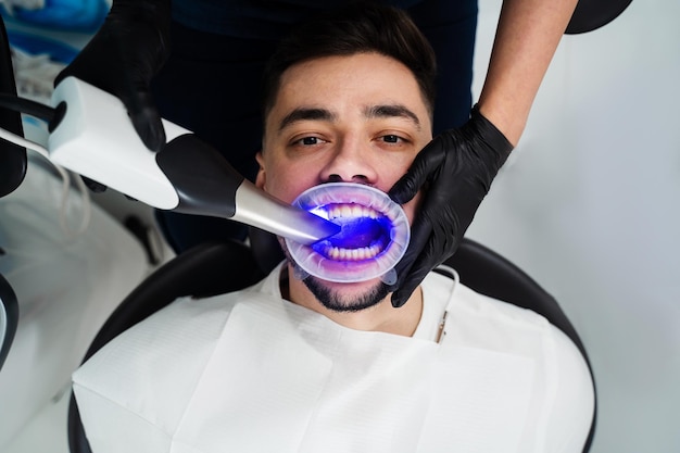 Photo dental scanner applying in stomatology clinic assessment of patient teeth condition with dental hardware