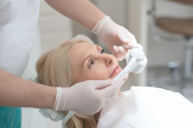 Dental surgery. A dentist getting his patient ready to the dental surgery