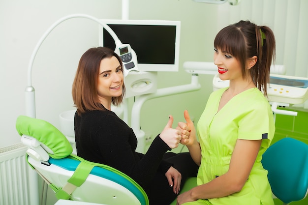 The dentist are treating teeth to client in dental office