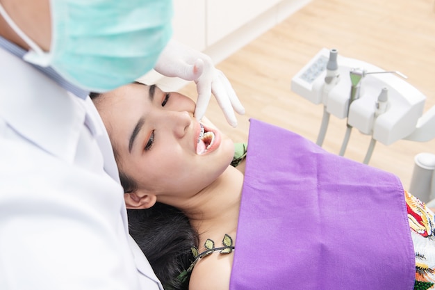 Dentist checking patient woman teeth