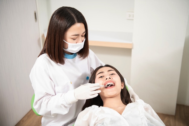 Dentist checking patient woman teeth