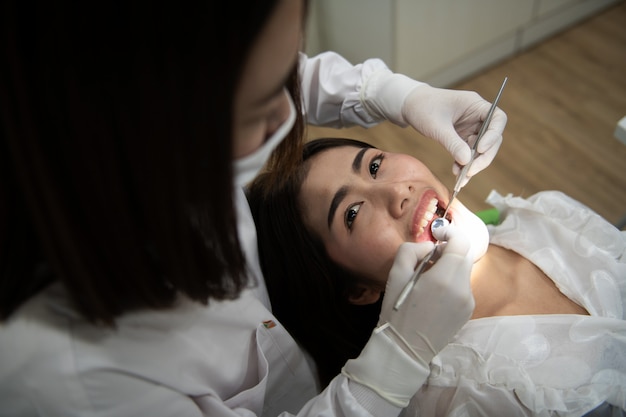 Dentist checking patient woman teeth 