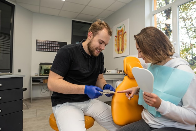 Dentist discusses dental problems with a female patient in a dental clinic