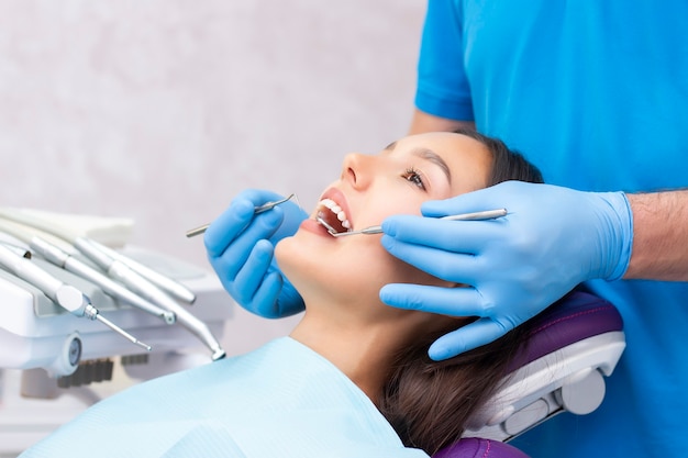 Dentist examines the patients teeth at the dentist. close up