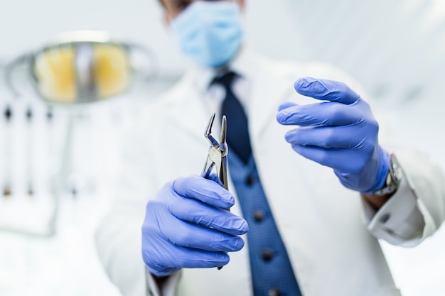 Dentist in his office ready for examination his patient's teeth. Selective focus.