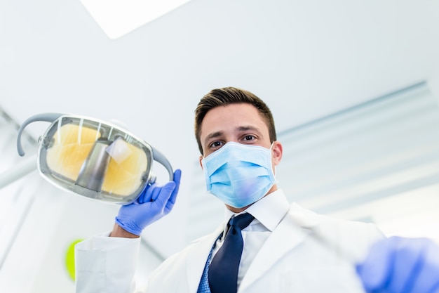 Dentist in his office ready for examination his patient's teeth.