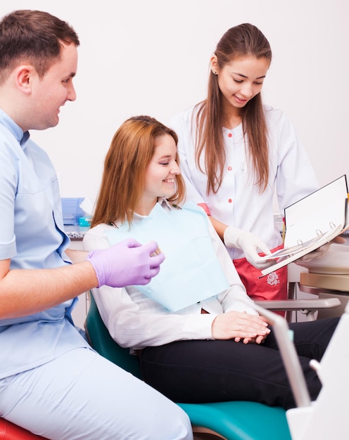 Dentist holding tooth model and choose the procedure