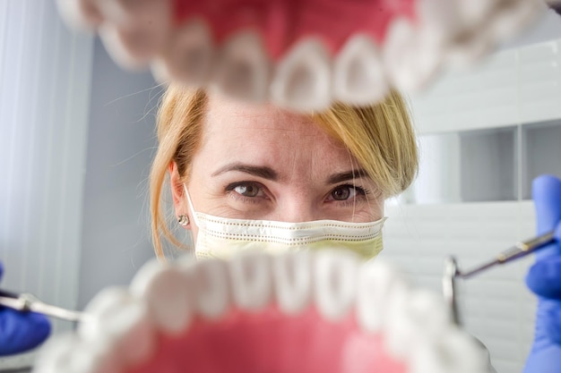 Dentist over open patient's mouth looking in teeth Oral care Inside vew