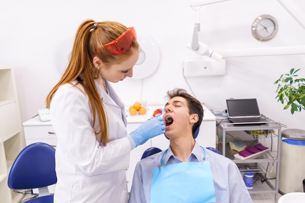 Dentist and patient during check up in clinic