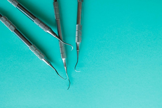 Dentist's tools on color background