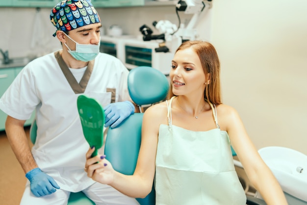 Dentist showing result of treatment for the patient.