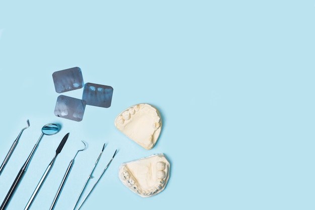 Dentist tools on a light blue surface