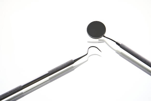 Dentist tools on white background with copy space closeup