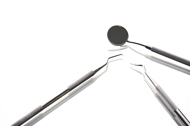 Dentist tools on white background with copy space closeup