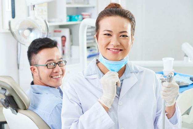 Dentist using dental drill for treatment