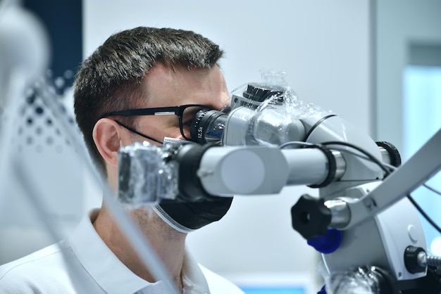 Dentist Using Microscope With Camera