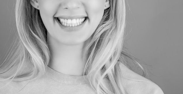 Dentistry concept Perfect healthy teeth Closeup shot of woman's toothy smile Perfect healthy teeth smile woman Black and white