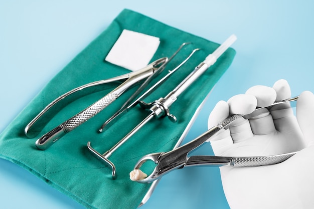 Dentistry medical tools forcept upper/ lower on blue background.