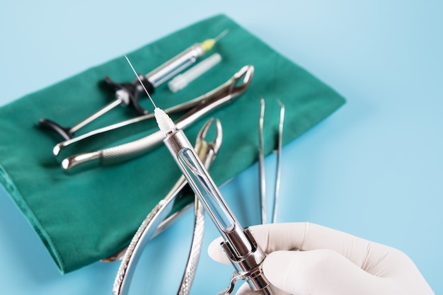 Dentistry medical tools syring on blue background.