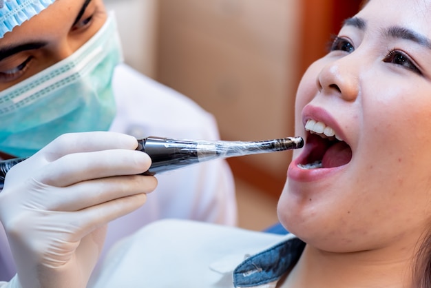 Dentistry and teeth healthcare concept at dental clinic. Dentist check-up teeth for young asian patient.