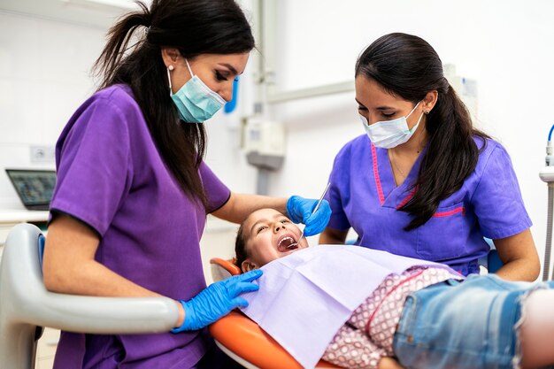 Dentists during a dental intervention with a patient. Dentist Concept