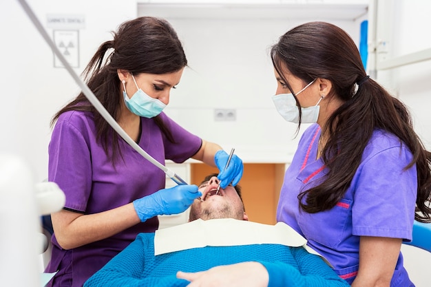 Dentists during a dental intervention with a patient. Dentist Concept