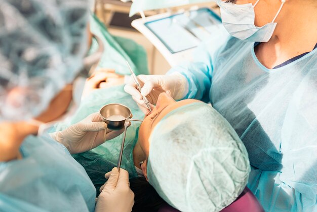 Dentists with a patient during a dental intervention. Medical Concept.