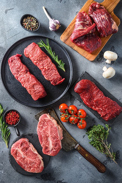 Denver steak on black plate, near top blade and flank steaks