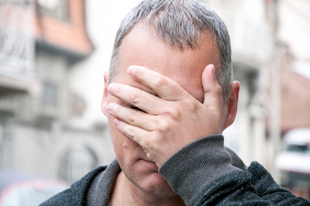 Depressed man walking through the city