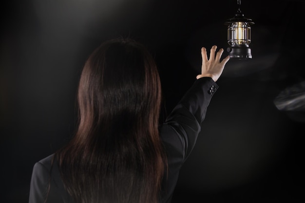 Depressed sad business woman looking and grab light lamp feeling lonely tired and worried suffering depression in mental health loneliness and isolation concept Low key copy space