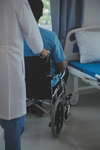 Depressed senior man sitting on the hospital bed alone at night he feels lonely and abandoned