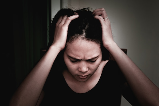 Photo depressed women sitting near curtain in living room, alone, sadness, emotional concept