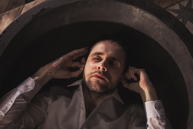 Depressed young man mental health in bathtub in bathroom at home