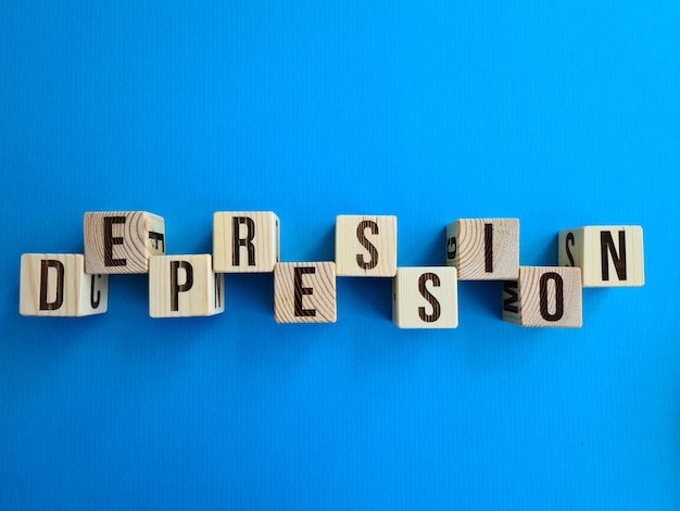 Photo depression written with wooden cubes on table