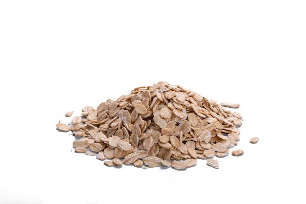 Depth of field of oat flakes isolated over white background. Uncooked oatmeal on white