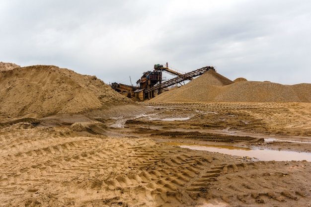 Photo desert industrial landscape with stationary rusty gravitational separator of sand and gravel on the horizon