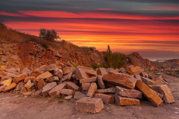 A desert landscape with rocks and huge stones in the foreground taken in a granite quarry in Ukraine