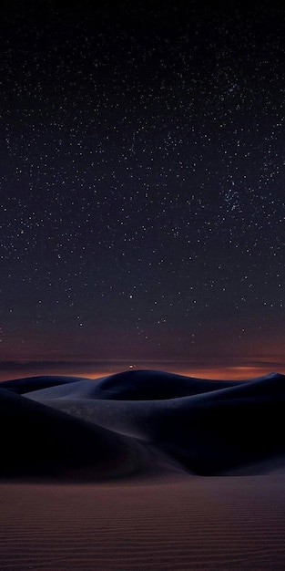 Photo a desert with snow and stars in the sky